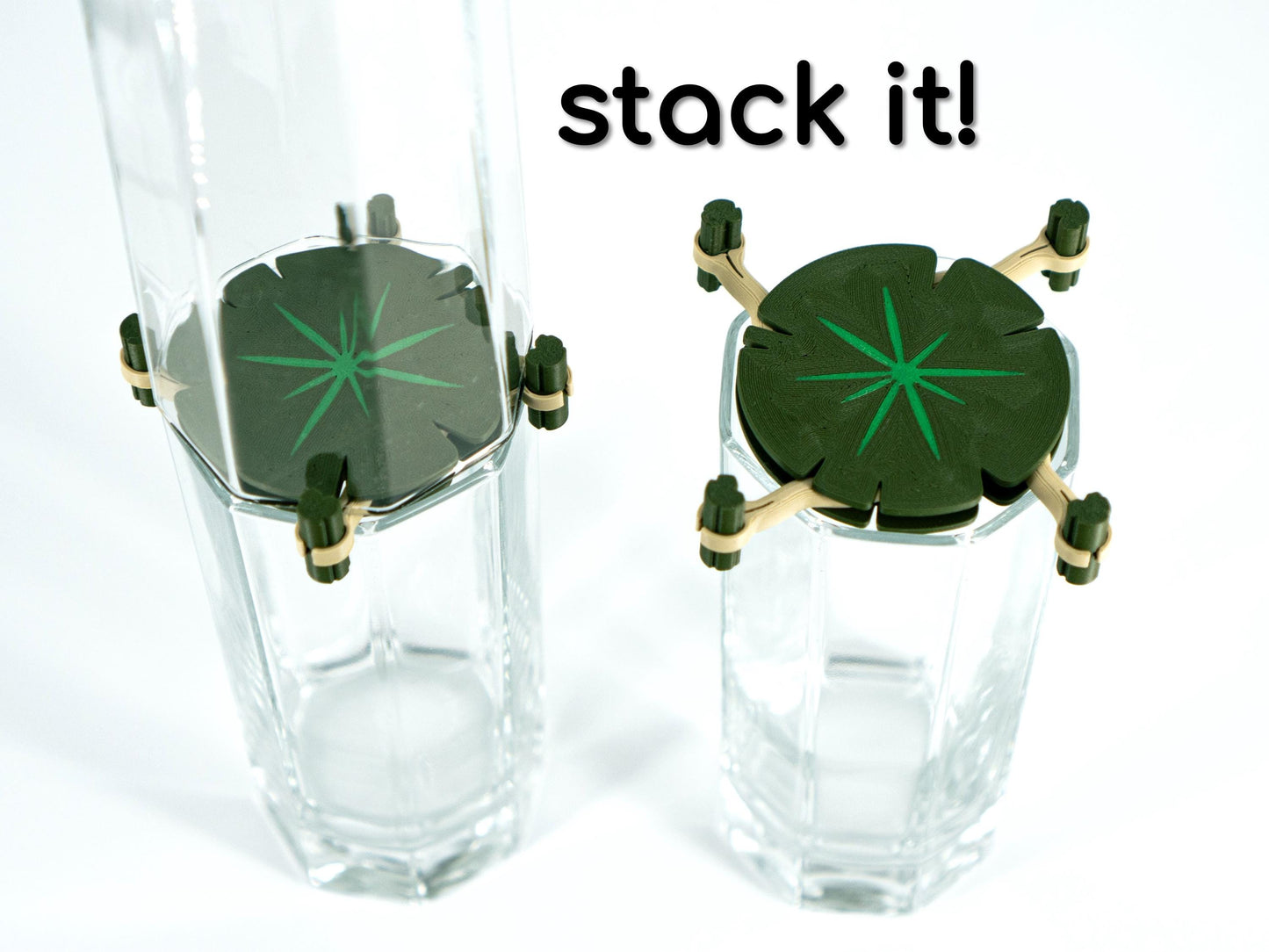 Two clear glass tumblers with green star-shaped drink markers on a white background, with text 'stack it!' above.