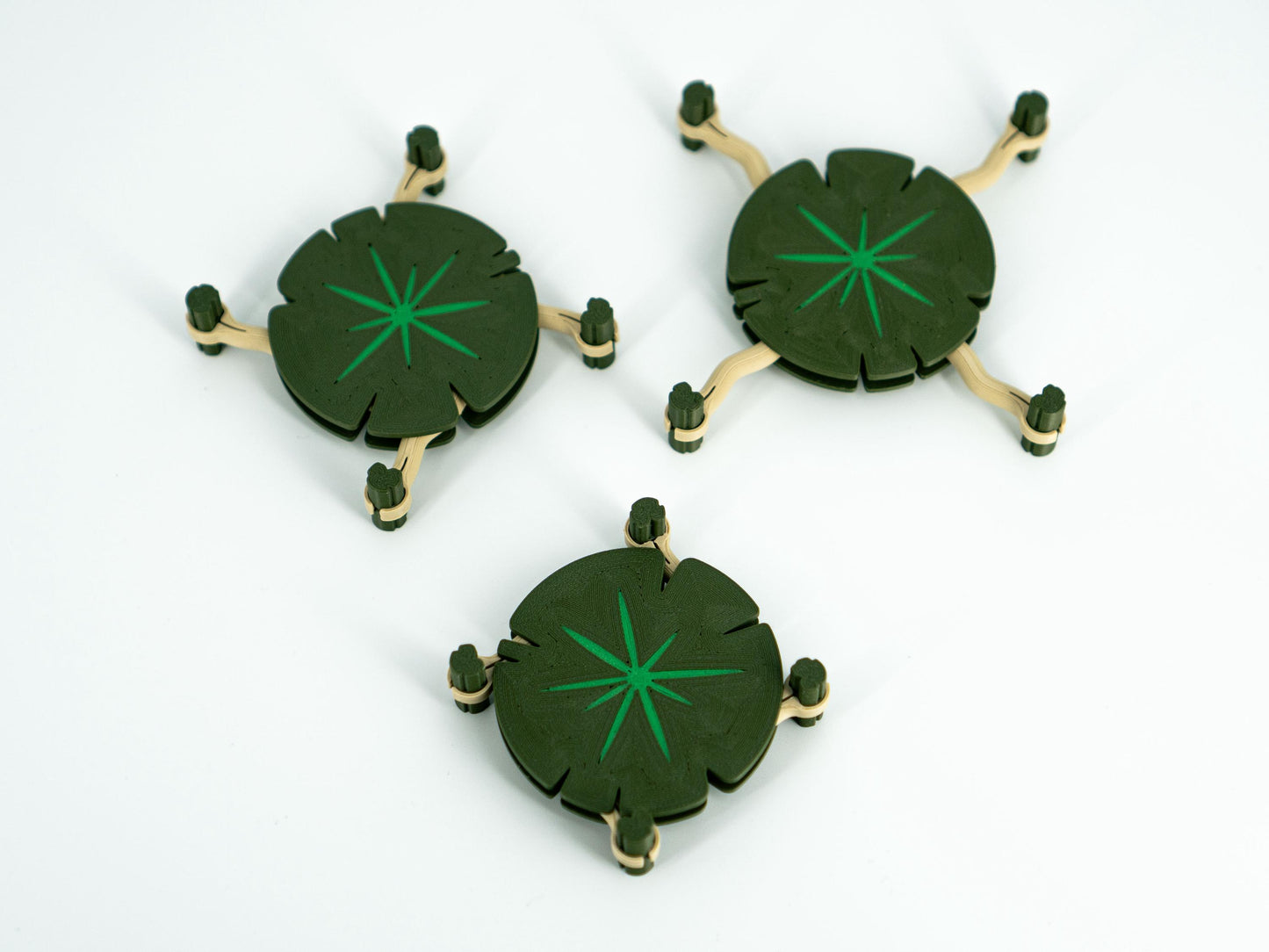 Three green circular objects with star patterns on a white background