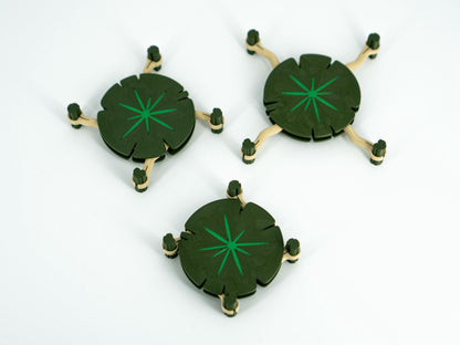 Three green circular objects with star patterns on a white background