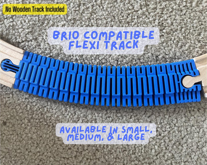 Blue flexible track curving between pieces of wooden train track